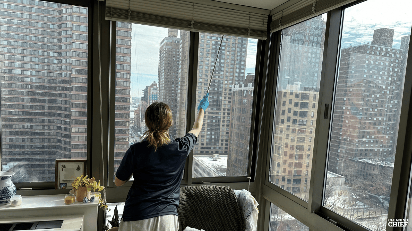 Residential cleaner dusts the windows in apartment in new york